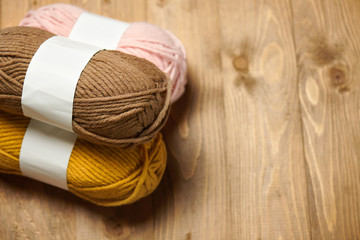 Fototapeta na wymiar colorful wool yarn for knitting on wooden background