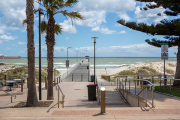 The grange jetty with a blue sky and white fluffy clouds looking from the esplande at Grange South...