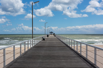 Obraz premium The grange jetty with a blue sky and white fluffy clouds at Grange South Australia on 7th November 2018