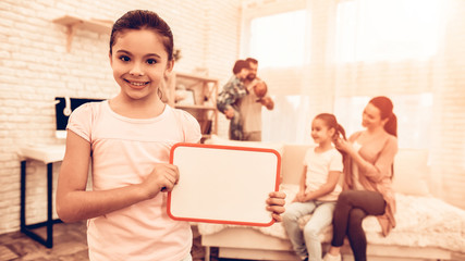 Little Girl Showing Blank Board near Cute Family