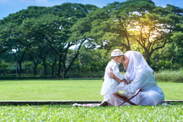 Asian Muslim Mother and her son smiling, hugging and kissing together, Muslim mom and child concept