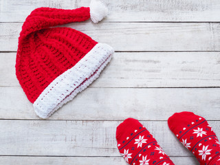 Selfie feet wearing red sock and Santa claus hat on vintage wood