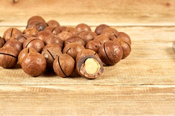 Macadamia nuts on wooden table with copyspace, close-up