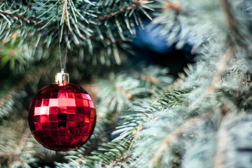 Bright Christmas decorations on the branches of the Christmas tree. selective focus. dramatic light