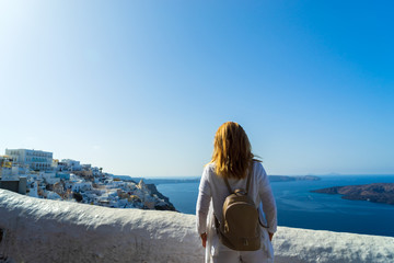 Luxury travel vacation woman looking at view on Santorini island