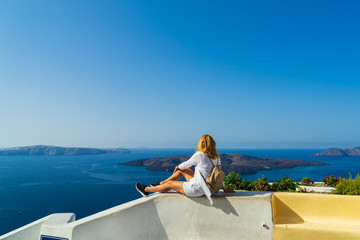 Luxury travel vacation woman looking at view on Santorini island