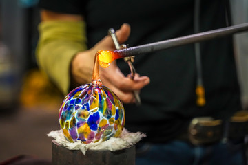 A Glass Blower Making a Beautiful Glass Orb - Powered by Adobe