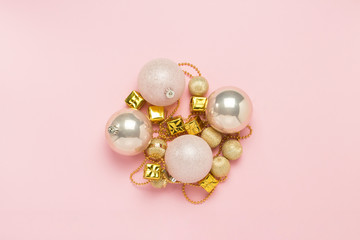Christmas decorations, balls, festoon on a light pink background. Merry Christmas and Happy New Year concept. Flat lay, top view