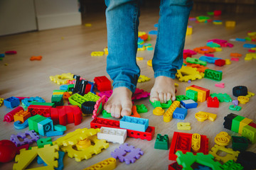 too much toys at home- little boy steps on toys trying to go through