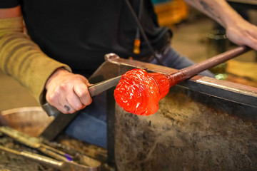 Molten Glass Being Formed By a Glass Blower - obrazy, fototapety, plakaty
