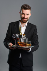 Sommelier carrying tray with beverages