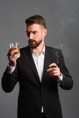 Rich man with drink and tobacco