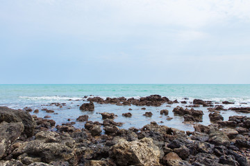 Fototapeta na wymiar Rocks on the beach and turquoise sea