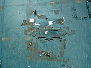 closed letterbox in an old green door