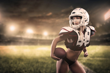 American football woman player holding ball on the stadium Panorama view