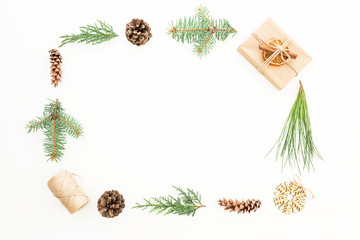 Creativity Christmas frame with gift, branches of winter tree and pine cones on white background. Flat lay. Top view