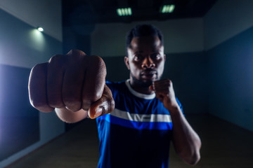 Black african american athletic man running on treadmills idoing exercises on muscle groups push up from the bench gym on black background