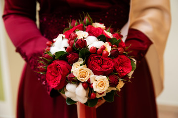 Wedding bouquet of flowers in the hands of the bride