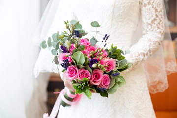 Wedding bouquet of flowers in the hands of the bride