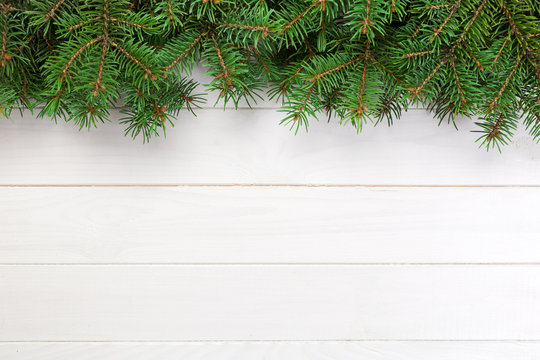 Christmas wooden background with fir tree and copy space. top view empty space for your design