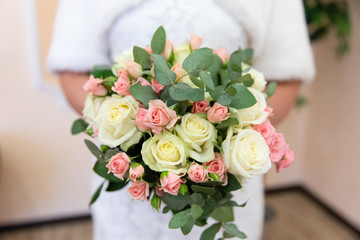 Wedding bouquet of flowers in the hands of the bride