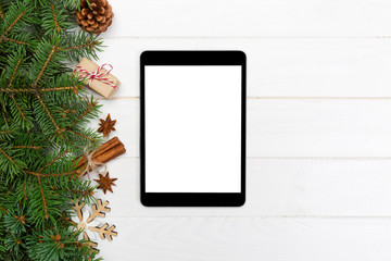 Digital tablet mock up with rustic Christmas wooden background decorations for app presentation. top view with copy space