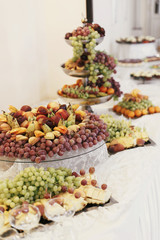 Delicious fruit table at wedding reception in restaurant. Fresh fruits. Luxury wedding catering
