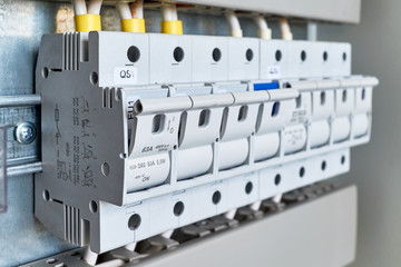 A range of fuse holders or disconnectors in an electrical Cabinet. The holders are fixed on the...