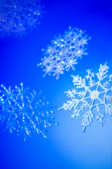 Decorative snowflakes on a blue background.  Merry Christmas or Happy New Year