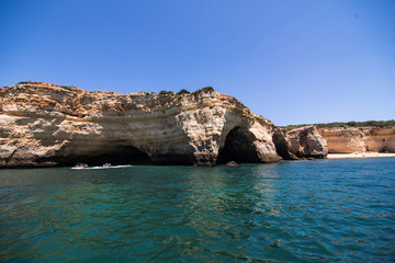 Fototapeta na wymiar Rocks, cliffs and ocean landscape at coast in AAlgarve, Portugal view from boat