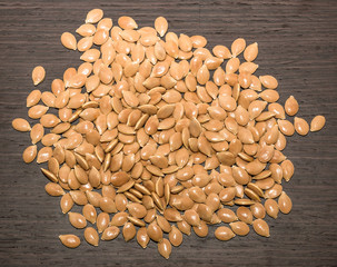 Fresh pumpkin seeds on a wooden tabletop