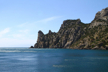 Fototapeta na wymiar Natural landscape photo of sea and mountains with light blue sky