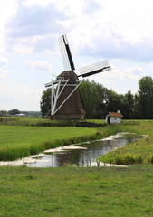 Dutch windmill Victor in polder landscape in the Frisian village Wanswerd.