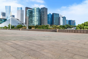 Fototapeta na wymiar Blue sky, empty marble floor and skyline of Hangzhou urban architecture.