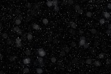 Falling snowflakes on a black background