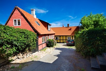 Fototapeta na wymiar Traditional colorful half-timbered houses in Gudhjem, Bornholm, Denmark