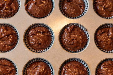 Circles raw chocolate muffins in metal tin