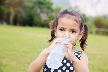 Cute girl drinking water.