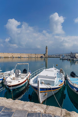 Fototapeta premium small motor boats in the harbor on against a cloudy sky background
