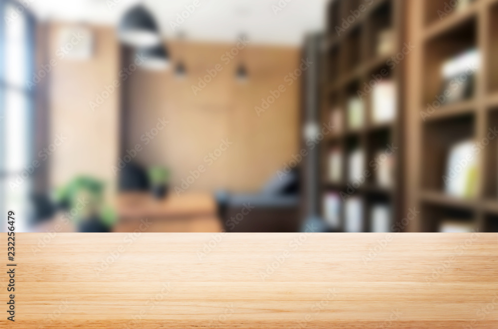 Wall mural wooden board empty table top and blur interior over blur in coffee shop background, mock up for disp