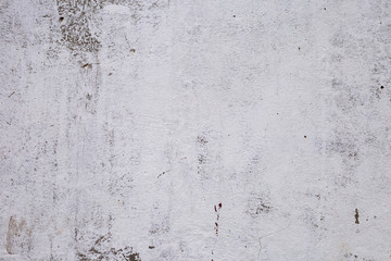 brick plastered wall with whitewash with potholes, cracks and stains, shot on a cloudy autumn day