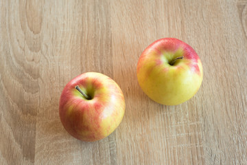 Ripe apples on a wooden background