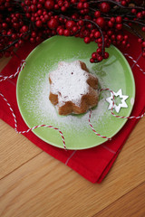 Italian Christmas cake called Pandoro on a plate on wooden table. Traditional food to celebrate Christmas holidays