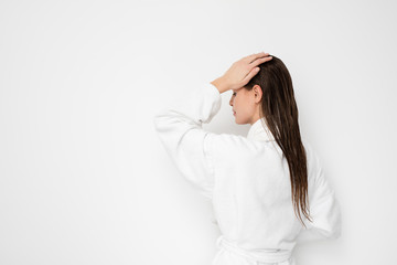 beautiful young woman with wet hair in bathrobe