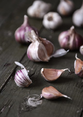 Garlic cloves on an old wooden table. Selective focus