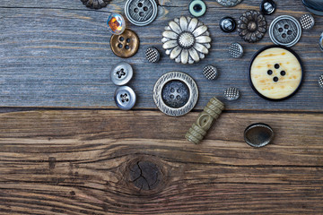 Vintage buttons on the old wooden surface