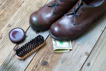boots, brush, shoe polish and dollar