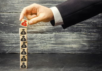 businessman removes a cube with a picture of dollars. financial and economic crisis. capital...