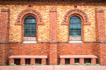 Old brick wall with twin arch window.