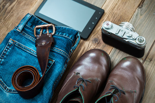 Set for the traveler with a digitizer, rangefinder camera, blue jeans and brown boots